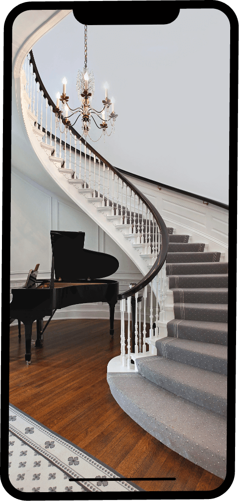 Elegant curved staircase with piano below