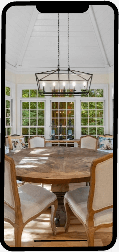 Phone screen showing dining area with tall, sloping ceiling